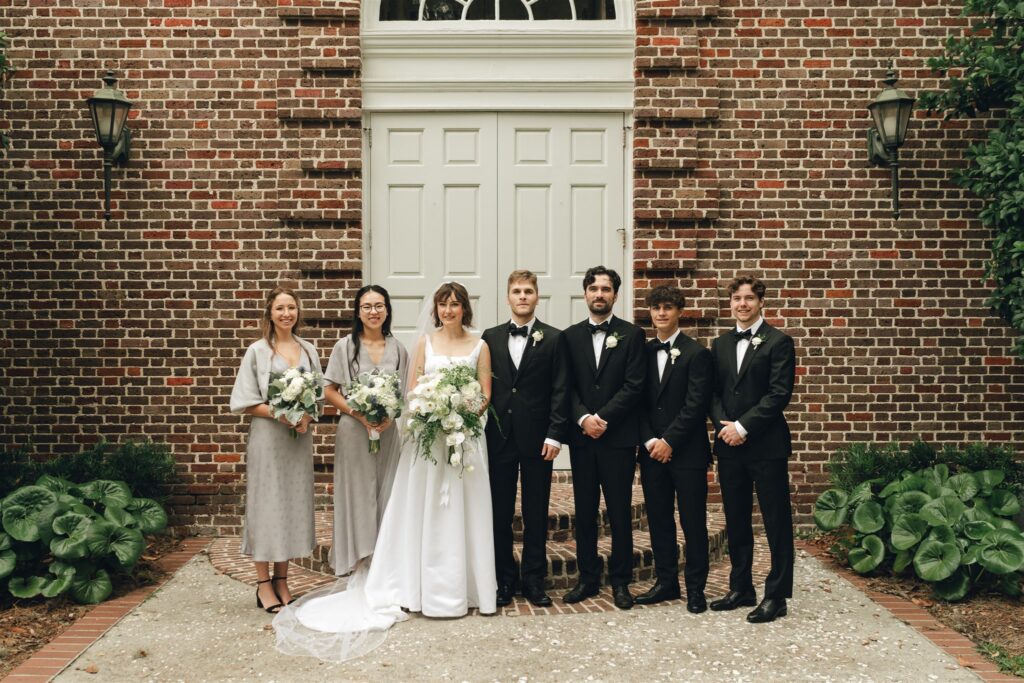 picture of the bride and groom with their bridesmaids and groomsmen 