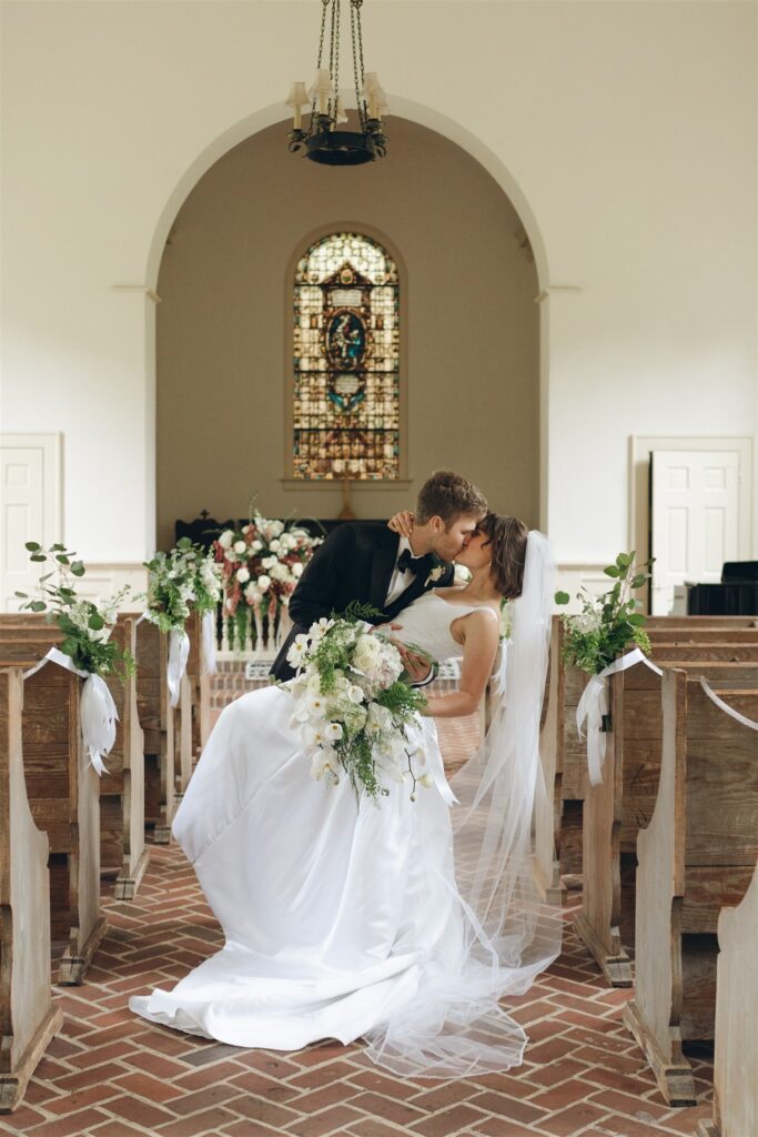 newly married couple kissing 