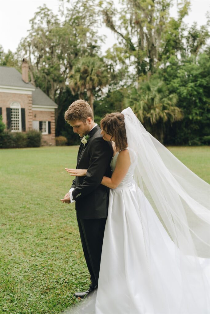 bride showing the groom her wedding ring 