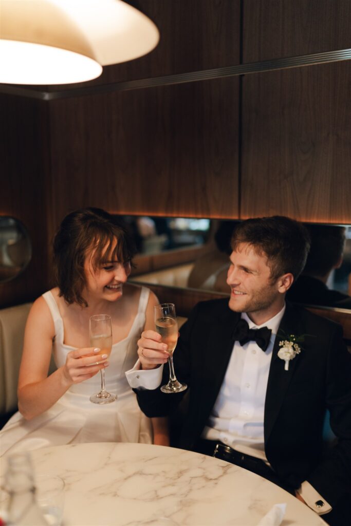 newly married couple celebrating with champagne 