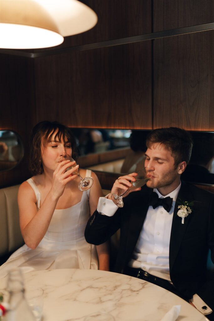 newly married couple drinking champagne