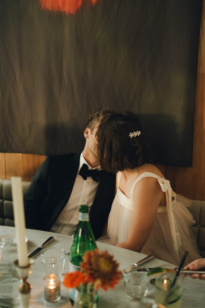 bride and groom kissing at their wedding reception