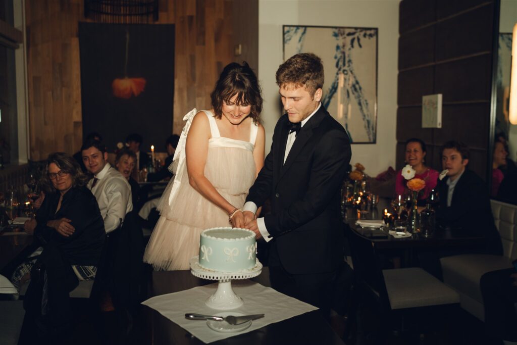 bride and groom cutting their wedding cake 