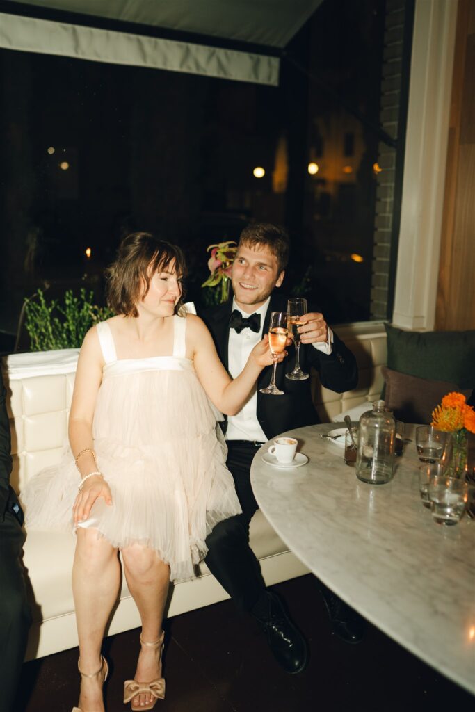 couple drinking champagne at their wedding reception