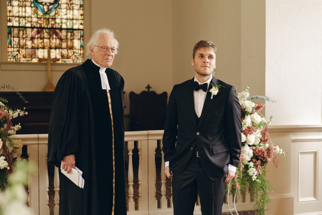 groom watching the bride walk down the aisle 