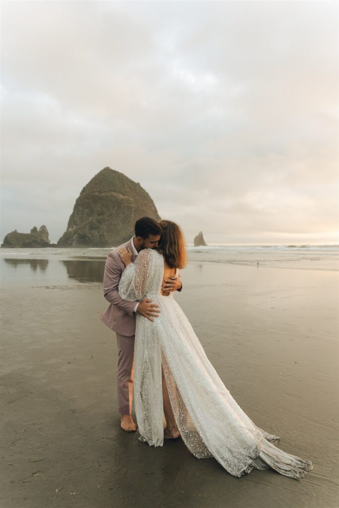 couple holding hands during their oregon coast elopement photoshoot 