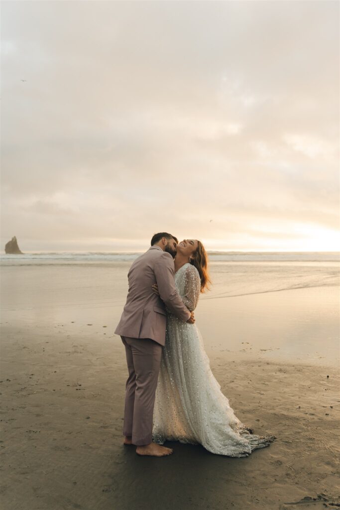 groom kissing the bride on the cheek 