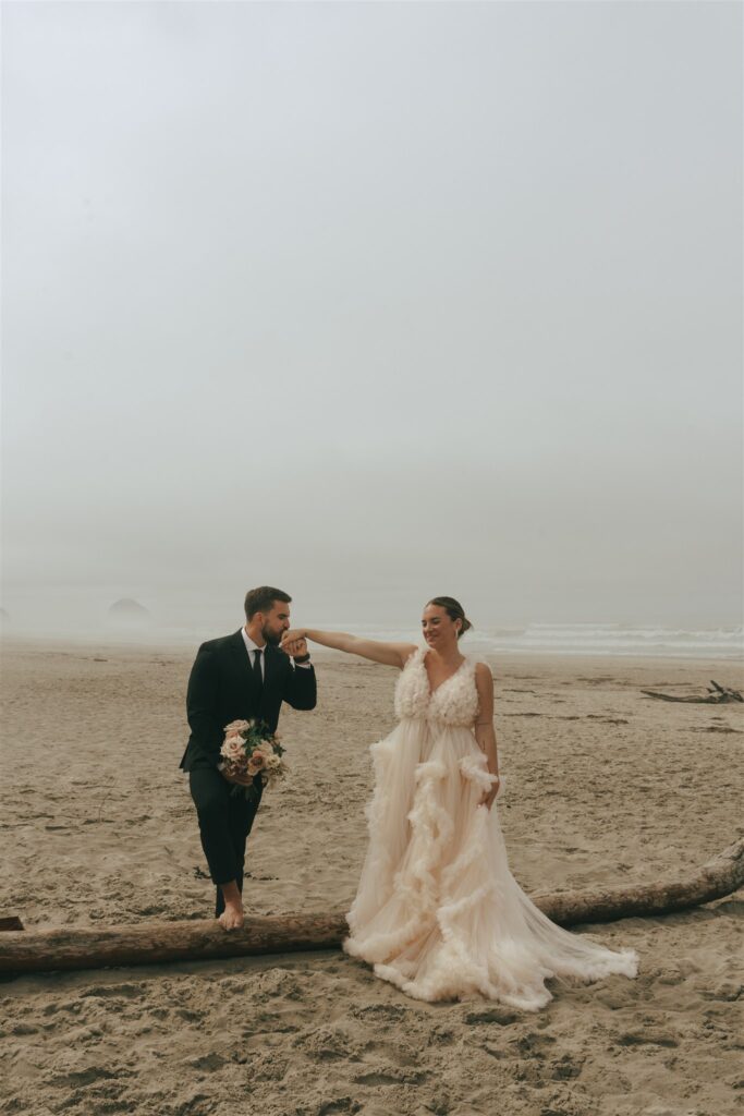 groom kissing the brides hand