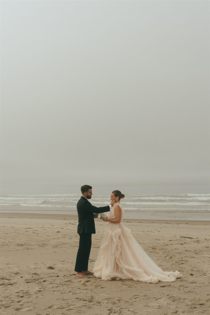 couple walking around cannon beach on oregon 