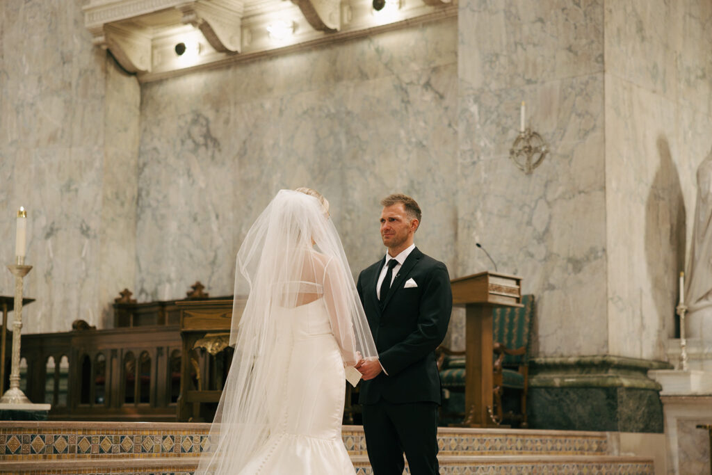 cute couple holding hands at their wedding ceremony 