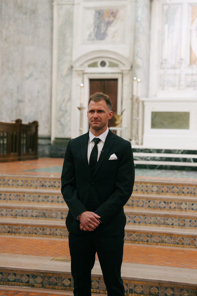 groom watching the bride walk down the aisle 