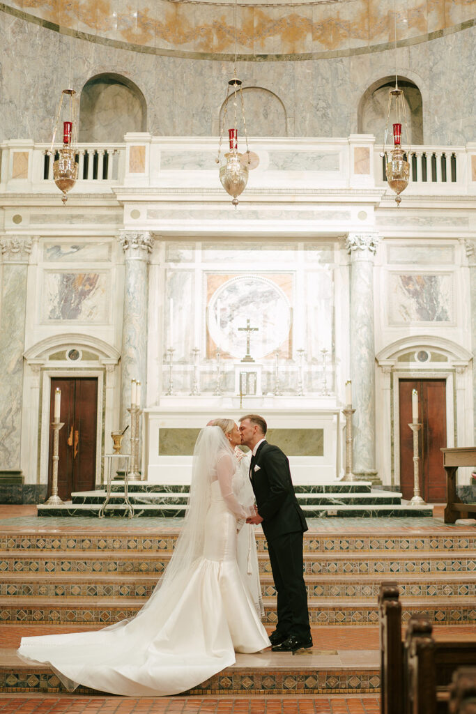 bride and groom kissing after their wedding ceremony