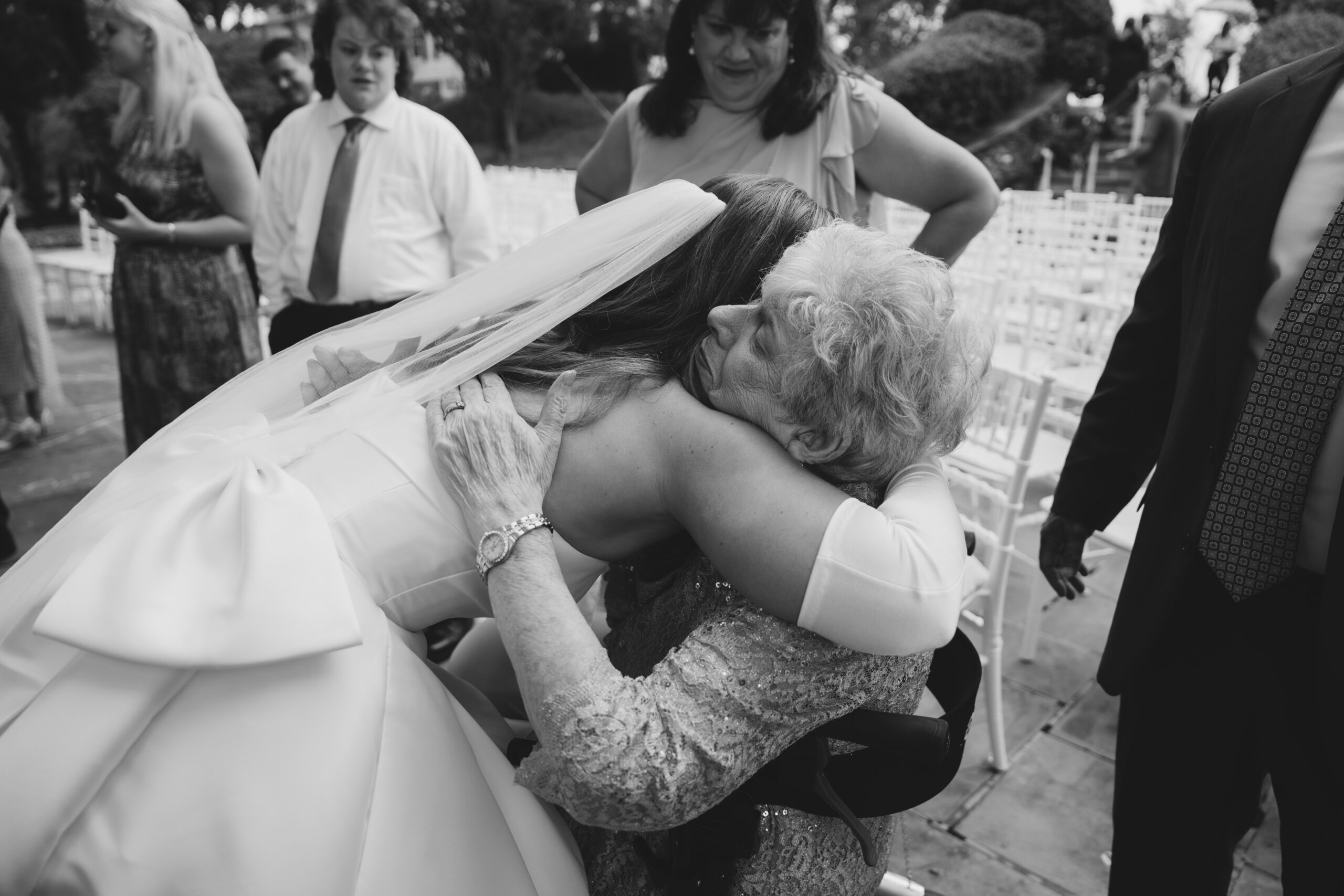 bride hugging grandmother after walking down the aisle