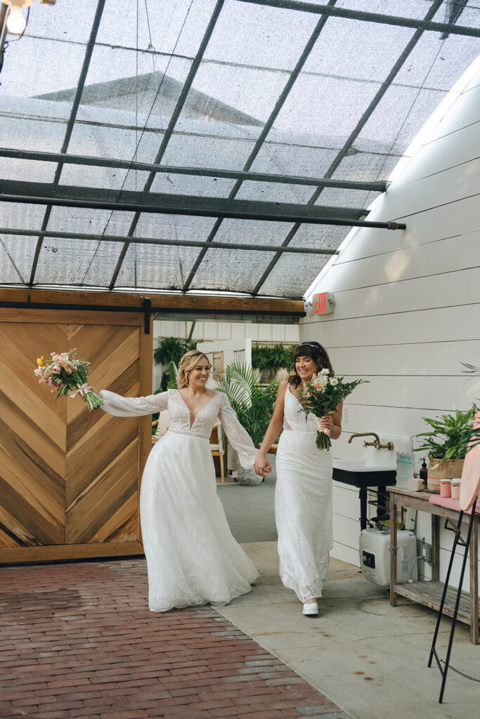 cute couple entering their wedding reception