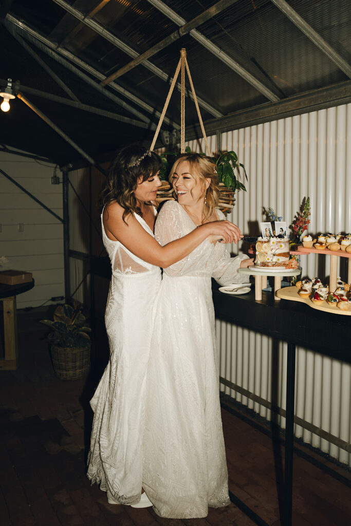 brides cutting their wedding cake 