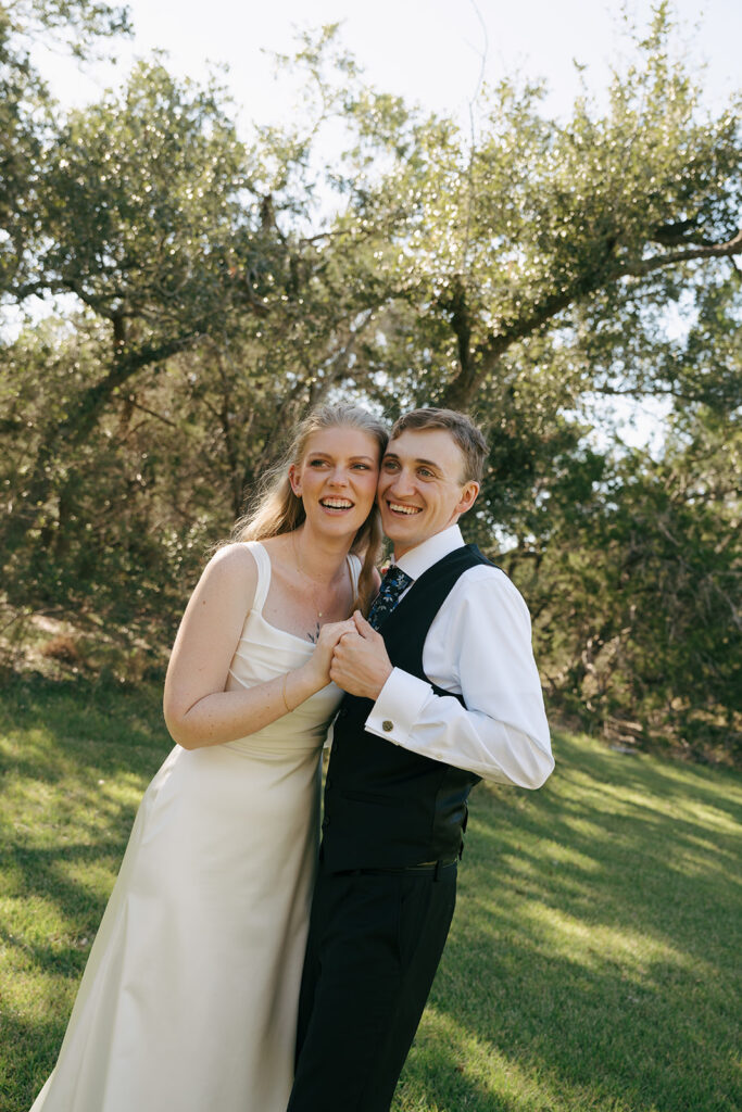 happy newly married couple looking at the camera