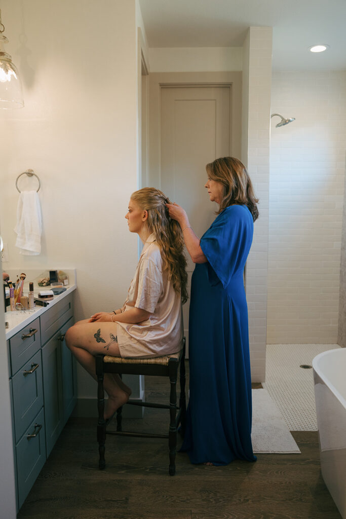 stunning bride doing her hair for her wedding ceremony 