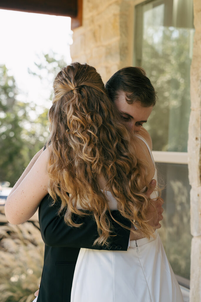 bride and groom hugging after their first look