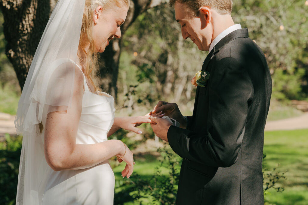 bride and groom exchanging wedding rings 