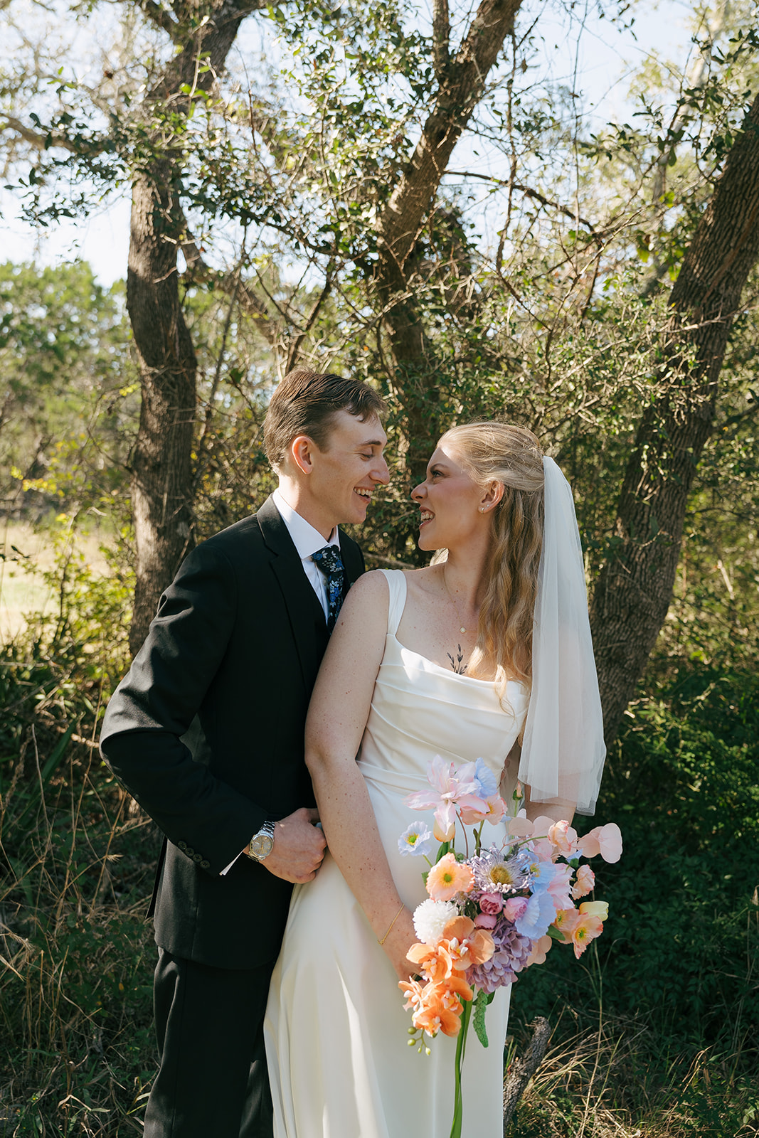 bride and groom looking at each other 