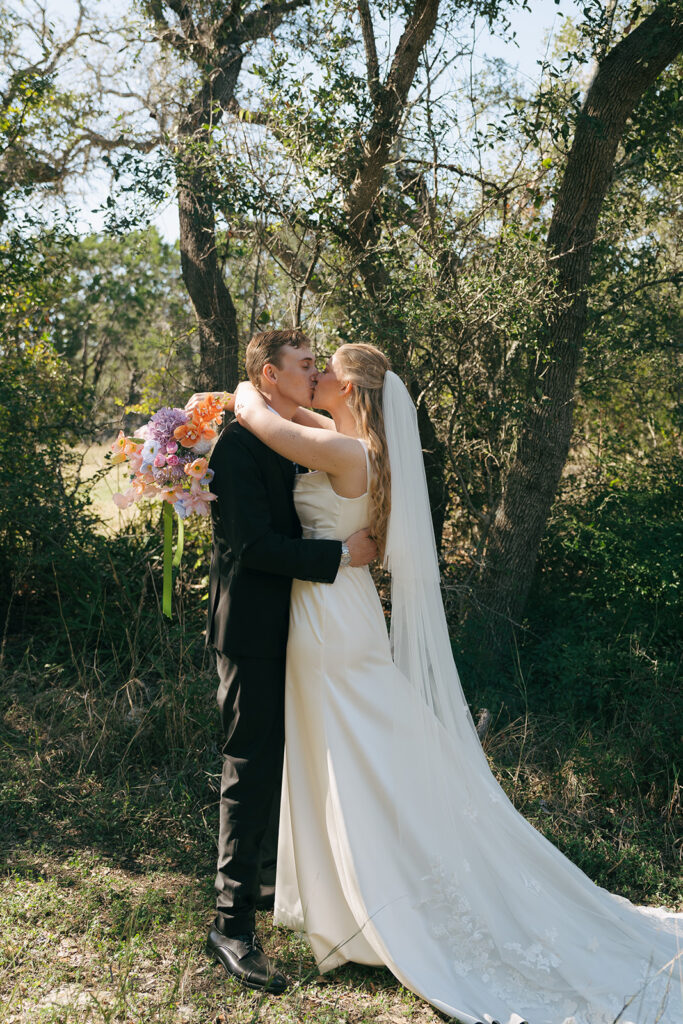 newly married couple kissing 