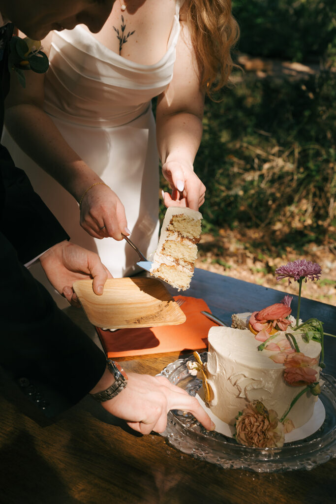 bride and groom cutting their wedding cake 