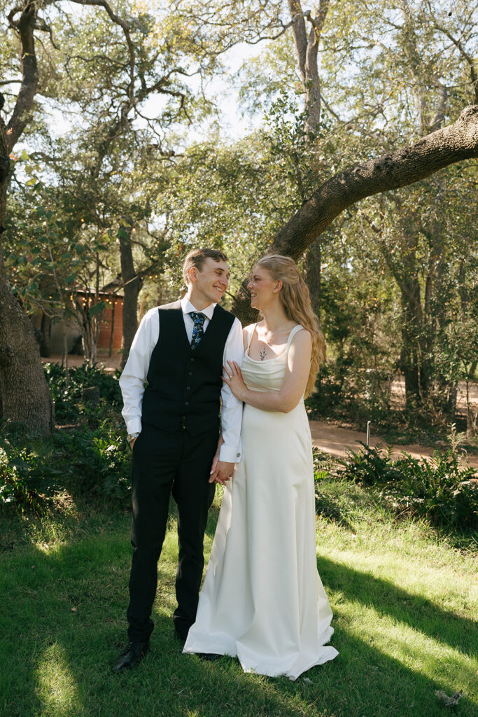 newlyweds looking at each other and holding hands 