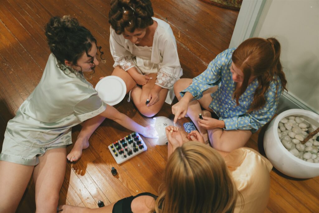 bride and her bridesmaids doing their nails