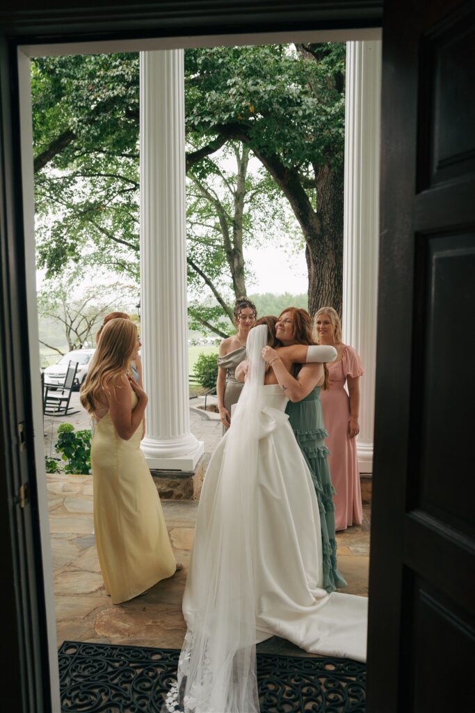 bride and her bridesmaids hugging