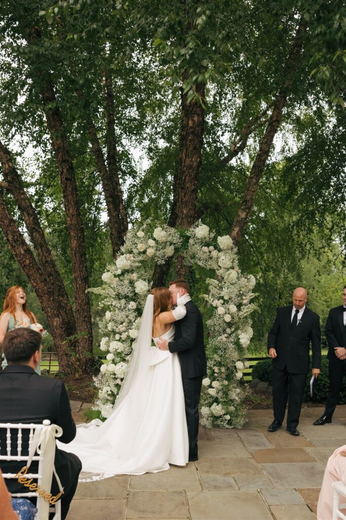 bride and groom kissing after their wedding ceremony 