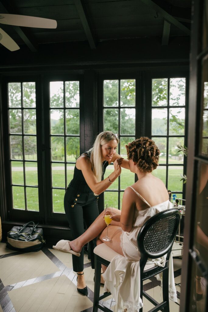 bride getting her makeup done for her coastal inspired wedding ceremony