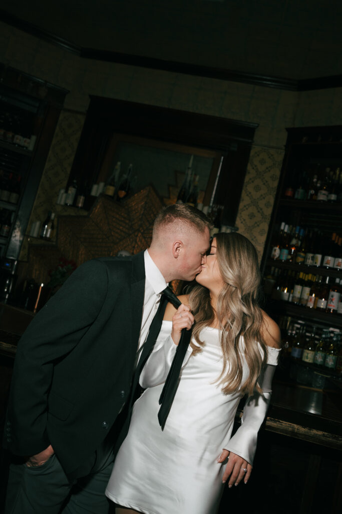 engaged couple kissing for flash photo at a bar in Nashville 