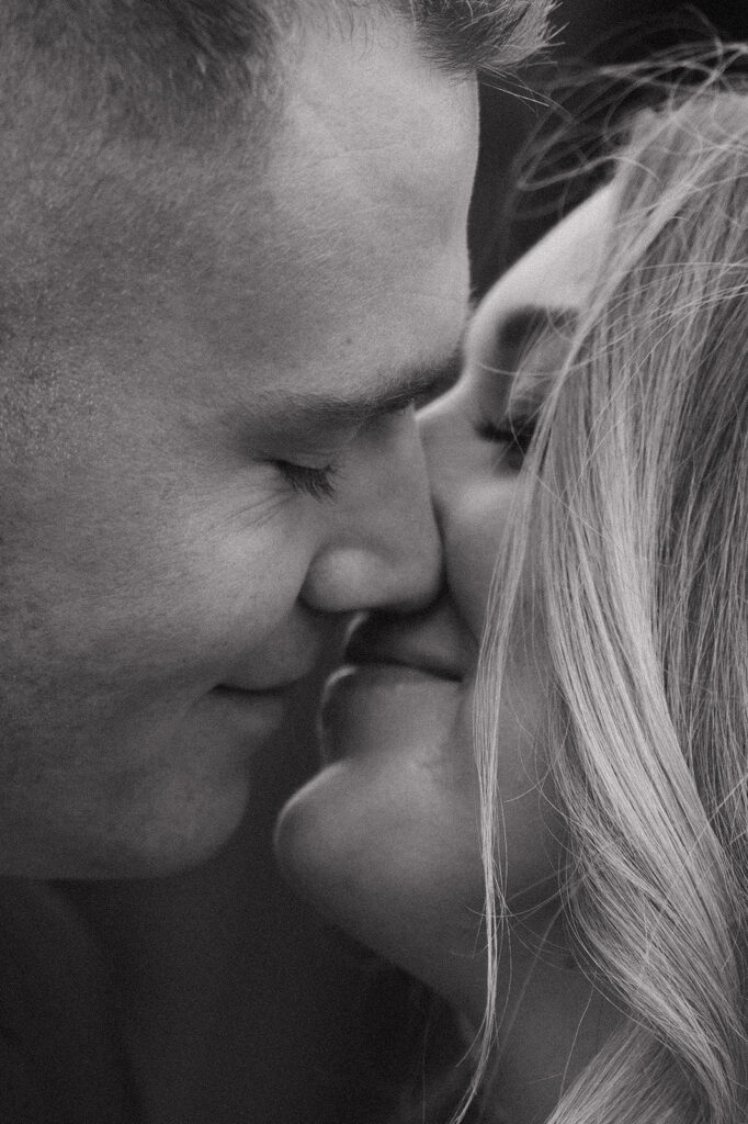 black and white intimate close up of couple almost kissing