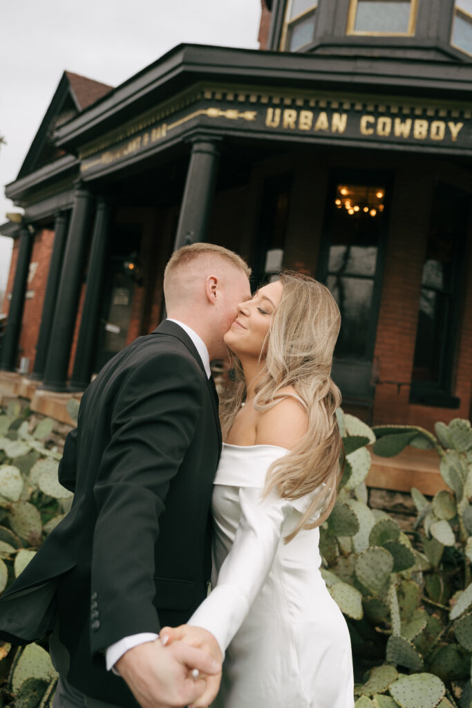 cute couple at urban cowbioy, nashville touching cheeks 