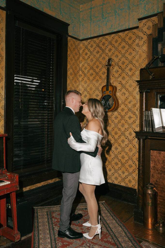 flash photo of couple dancing at their engagement shoot in a Western themed parlor