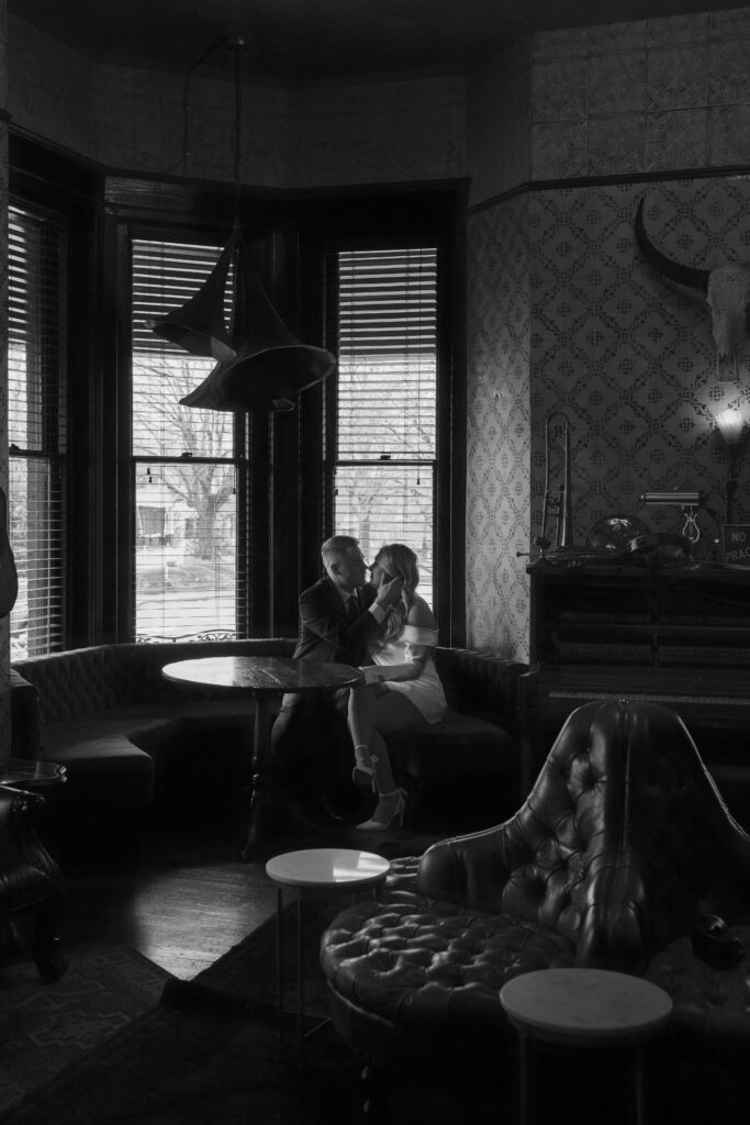 couple whispering in each other's ear at a western themed bar