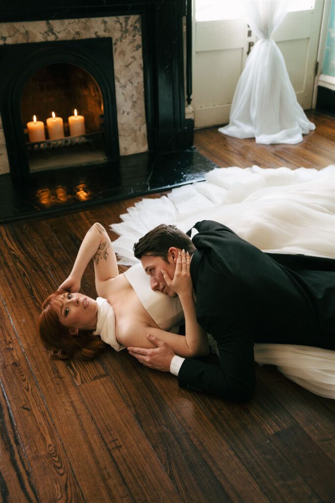 wedding couple posed laying on the ground 