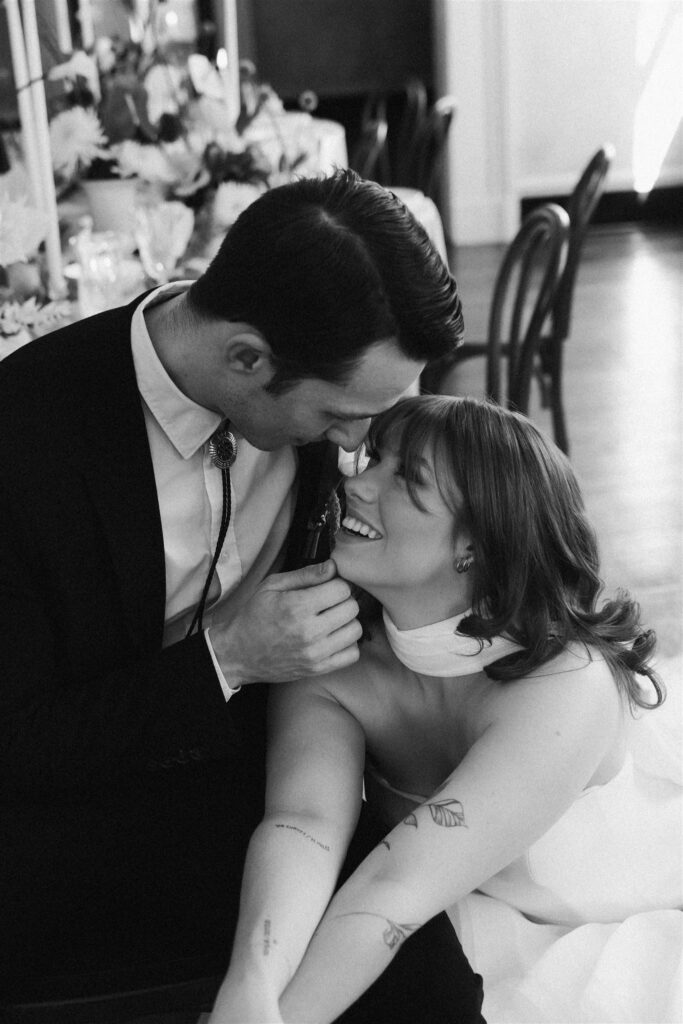 black and white photo of sweet moment at a wedding