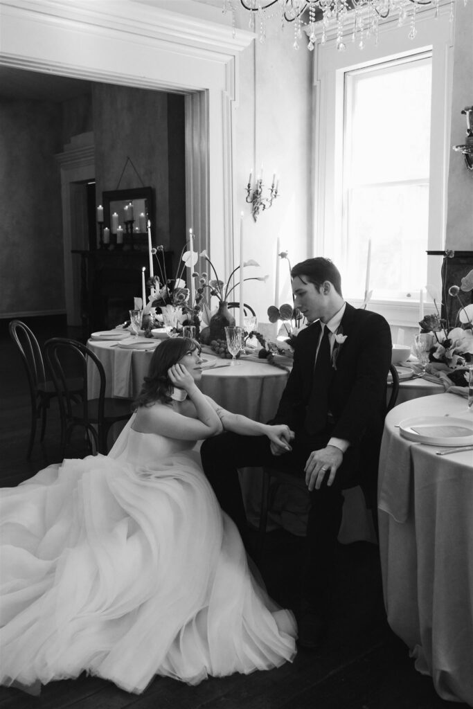 black and white editorial couple holding hands at a wedding 