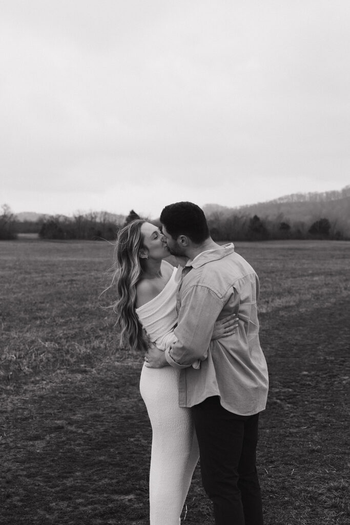 black and white photo of couple kissing in maternity photos in nashville 