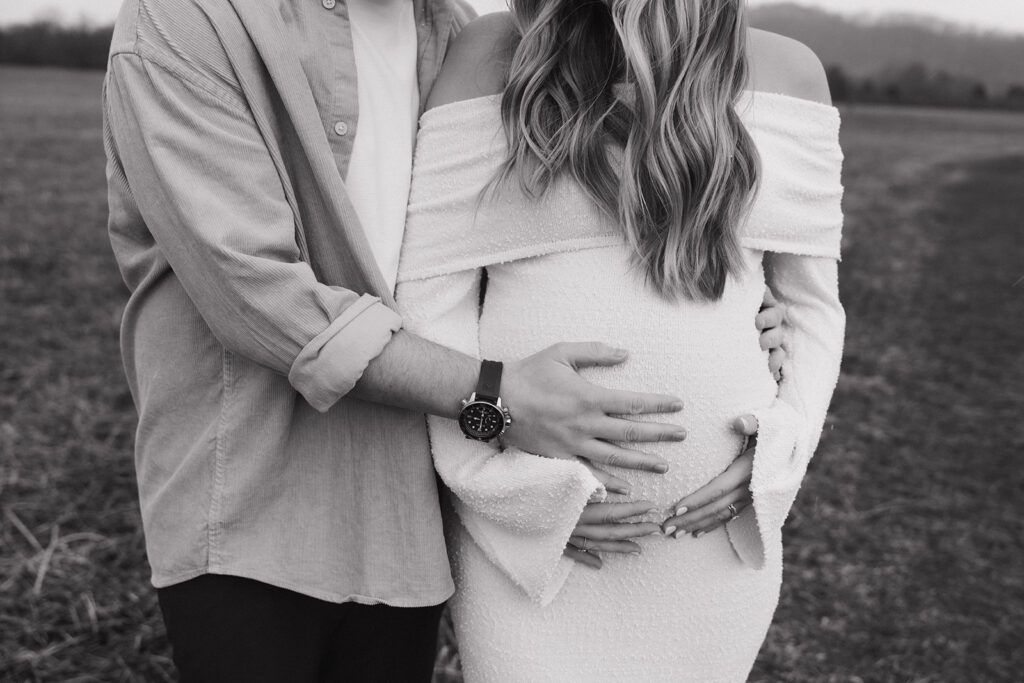 hands on baby bump with a white dress 
