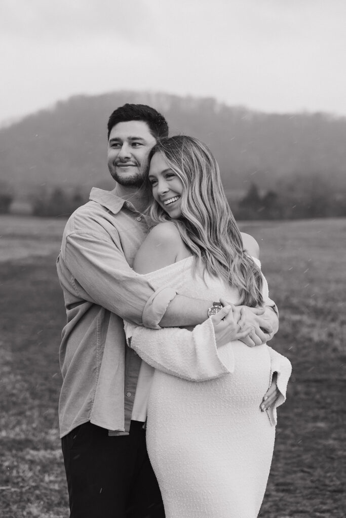 maternity couple at photoshoot hugging from behind 