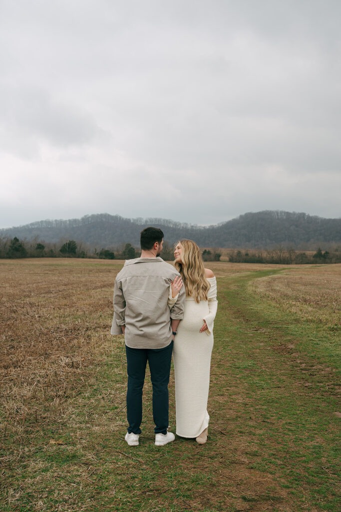 maternity couple leaning in to each other for maternity photos 