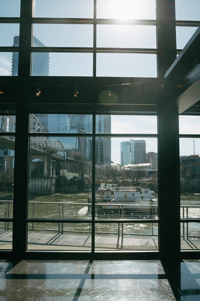 large window with natural light coming through with a view of downtown Nashville from wedding venue 