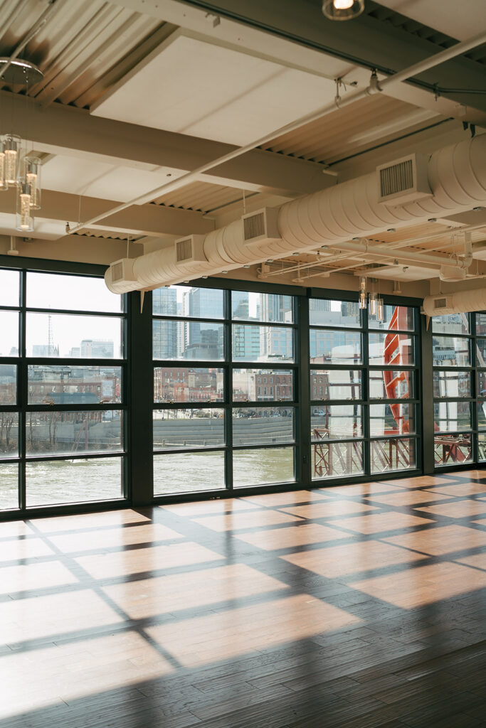 big windows at nashville wedding venue with view of skyline 