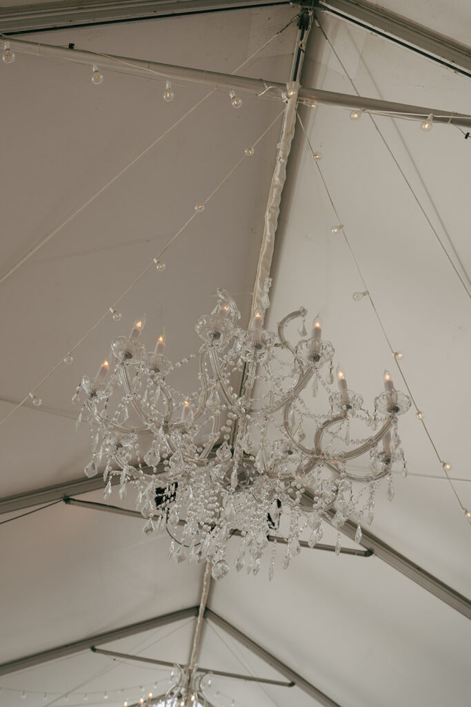 crystal chandelier in big white tent at Nashville wedding venue 